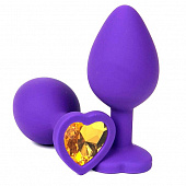 Фиолетовая силиконовая анальная пробка с оранжевым стразом-сердцем - 8,5 см.