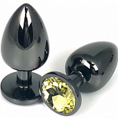 Черная металлическая анальная пробка с желтым стразом - 6,5 см.