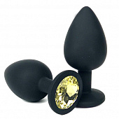 Черная силиконовая анальная пробка с желтым стразом - 8 см.